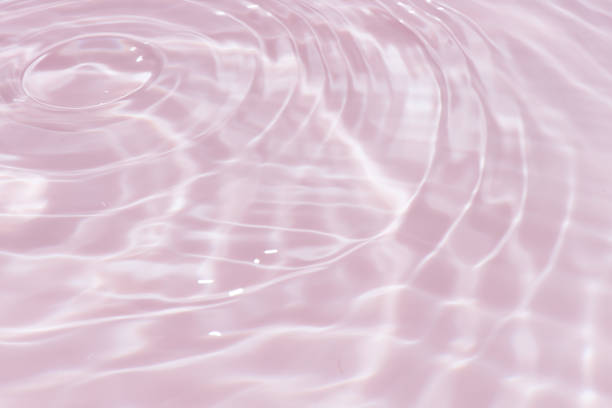 istock Defocus blurred transparent gold colored clear calm water surface texture with splashes reflection. Trendy abstract nature background. Water waves in sunlight with copy space. Yellow  watercolor shine. 1732768299