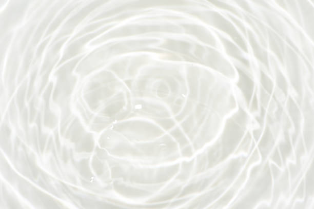 istock Defocus blurred transparent gray colored clear calm water surface texture with splashes reflection. Trendy abstract nature background. Water waves in sunlight with copy space. Blue watercolor shine. 1732769980