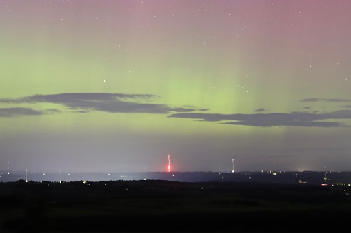 Green and pink Northern Lights above Northumberland