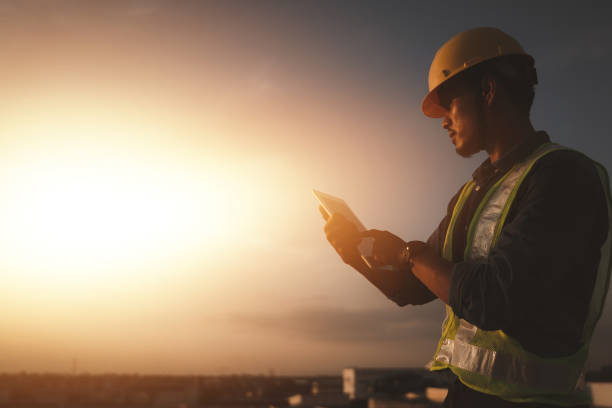 istock Engineer using tablet to inspect work at job site. concept of technology usage In industrial applications, remote data retrieval, large databases. network link. 1732839262