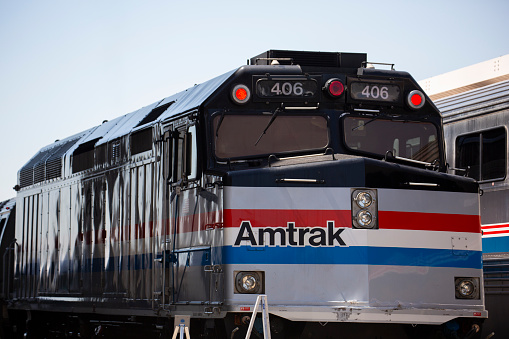 Los Angeles, California, USA - July 16, 2023: An Amtrak passenger train engine pulls into Union Station.