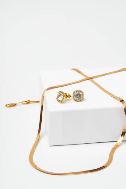 istock Golden diamond neacklace and earrings on white background 1732877473