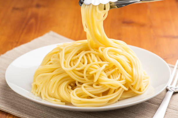 istock Serving Pasta onto Plate with Tongs 1732898015