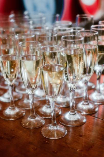 istock Array of sparkling crystal glasses filled with champagne atop a rustic wooden table 1732909920