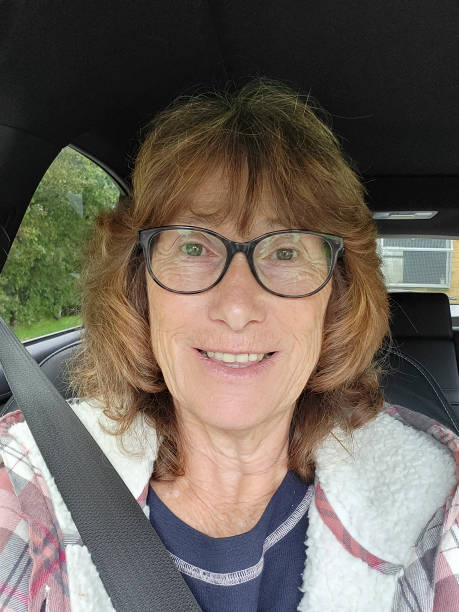 istock Woman sitting in a car taking a selfie. 1732920612
