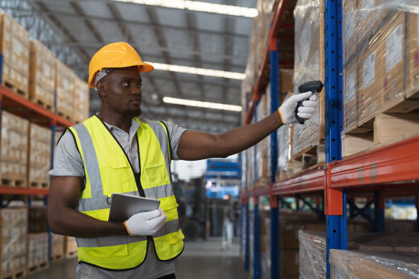 istock Male warehouse worker scanning barcodes on boxes on shelf pallet in the storage warehouse. Male worker inspecting quality of barcodes of products in the warehouse 1732930567