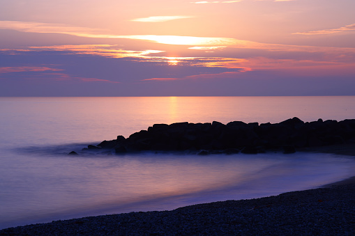 Sunset across rock peninsula