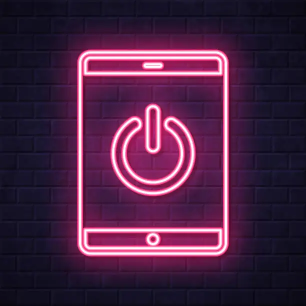 Vector illustration of Tablet PC with power button. Glowing neon icon on brick wall background