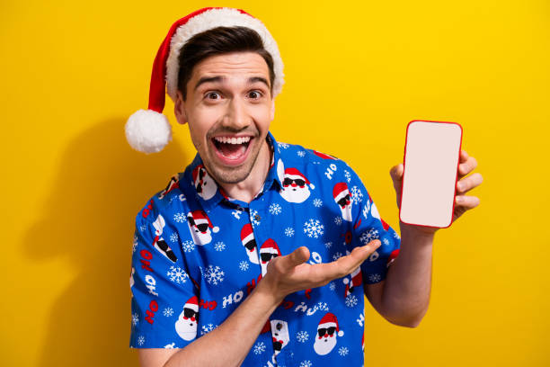 istock Portrait of handsome astonished guy demonstrate empty space samrt phone screen proposition isolated on yellow color background 1732952908