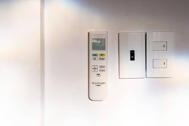 istock Air conditioner remote control hanging on wall. 1732992730