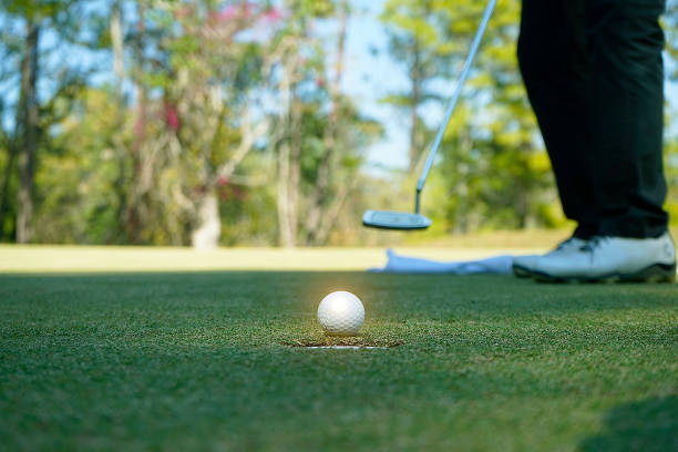 美しいゴルフコースの緑の芝生の上のゴルフボール - putting green practicing putting flag ストックフォトと画像