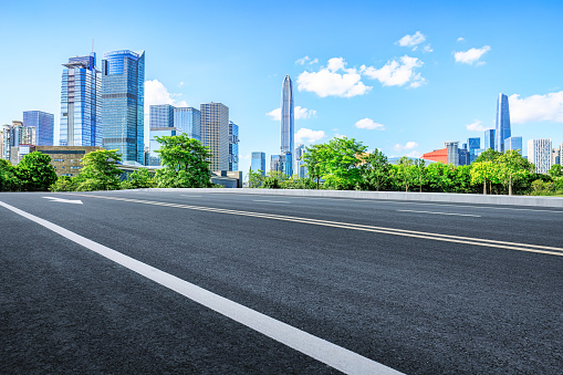 Clean asphalt road and city financial district skyline background in Shenzhen, China