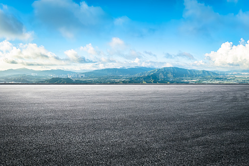 Clean asphalt road with mountains and skyline background in Shenzhen