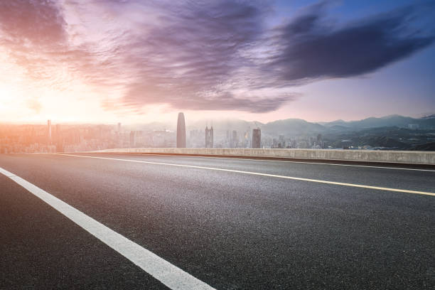 Clean asphalt road and city financial district skyline background in Shenzhen, China