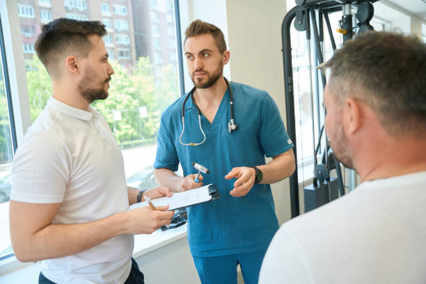 istock Doctor and fitness coach discussing client workout plan 1733049332