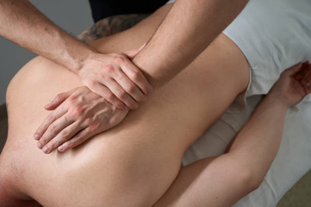 istock Physiotherapist alleviating patient upper back pain 1733049477