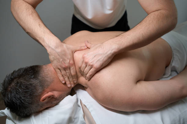 istock Experienced massotherapist giving cervical spine massage to client 1733050003
