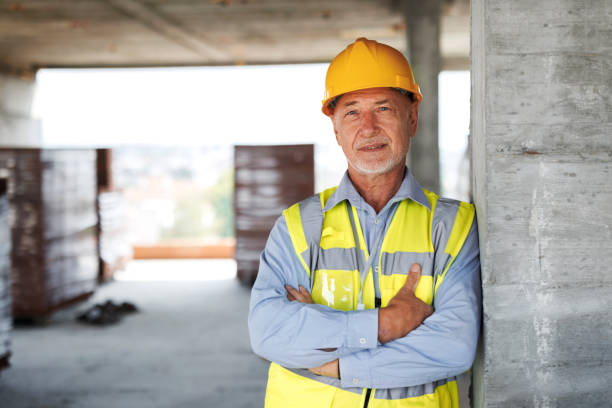 istock Portrait of senior construction worker with yellow hardhat 1733052809