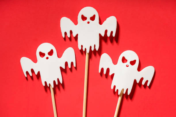 istock Scary white ghosts on red background. Halloween decoration. Horror concept 1733063613
