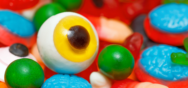 Creepy Halloween Confections: Jelly Finger, Eyeball, Spider, Brain, Tongue, and Bone Sweets. Banner