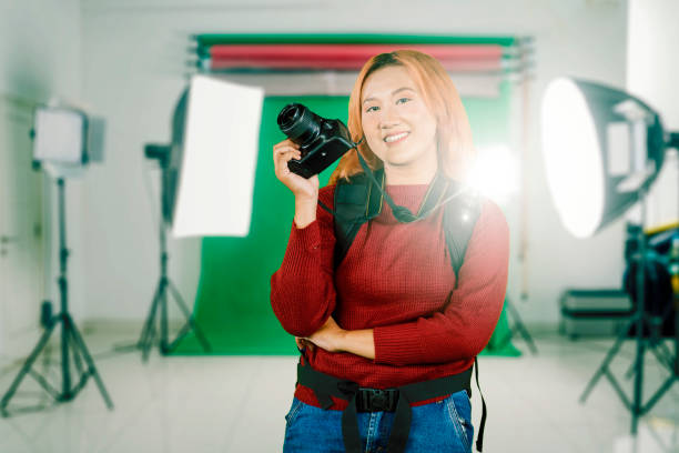 istock Young female photographer holding a camera in studio 1733092966
