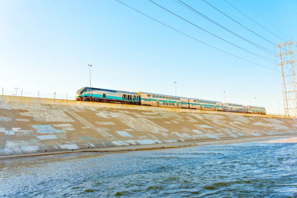 Los Angeles, California – January 21, 2023: Metrolink train passing alongside the LA River