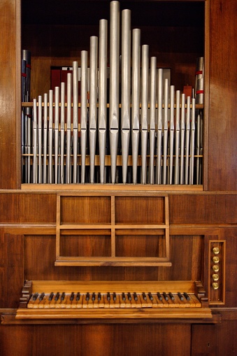 A close-up of a beautiful, classic pipe organ in an Italian church