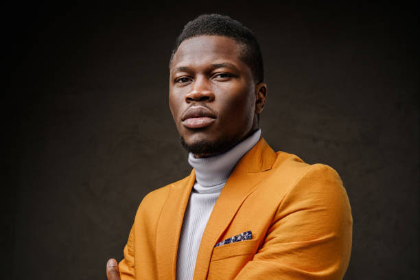 istock Stylish dark-skinned man wearing a yellow blazer 1733110040