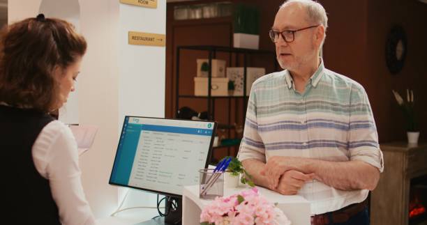 istock Receptionist looks at passport info 1733121723