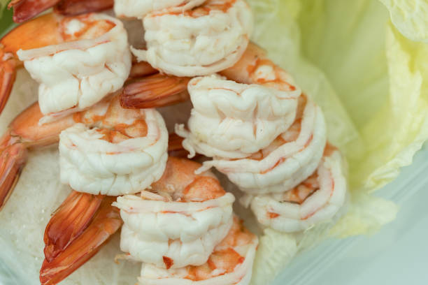 Homemade boiled shrimp appetizer served on fresh lettuce. Close up