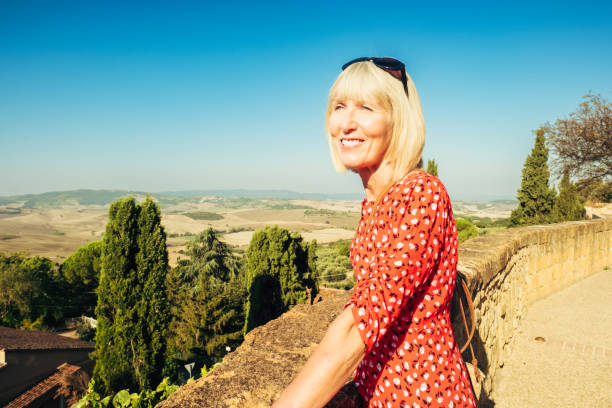 Female tourist exploring the Tuscan village of Pienza, Italy.