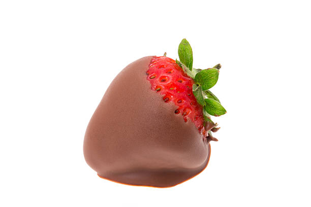 Strawberry dipped in milk chocolate Stawberry that has been dipped in milk chocolate - studio shot with a white background chocolate covered strawberries stock pictures, royalty-free photos & images