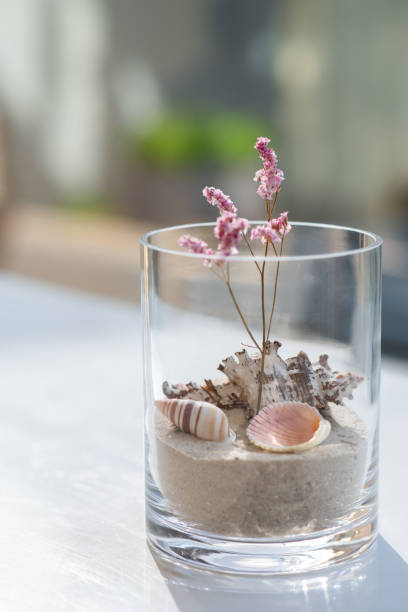 istock A decorative glass for home with shells and sand in it. 1733128922