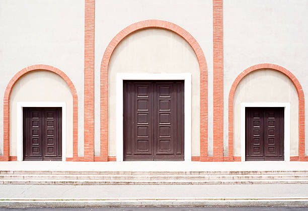 Church facade with three doors and arches. Milan, Italy.