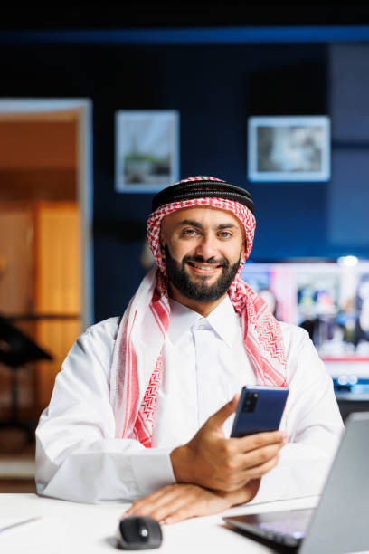 istock Smiling Muslim guy holding a cell phone 1733148574