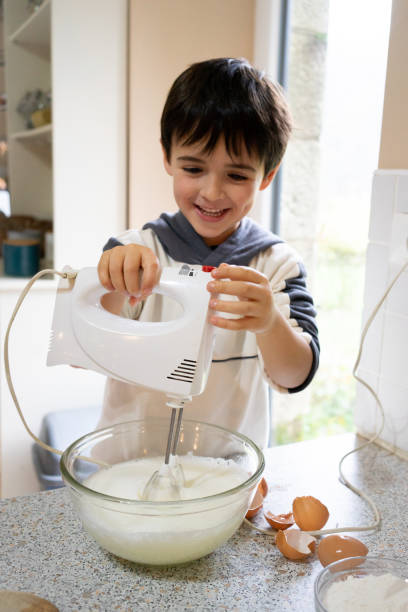 istock brother and sister baking a cake for Christmas 1733150248