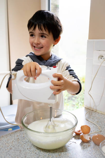 istock brother and sister baking a cake for Christmas 1733151370