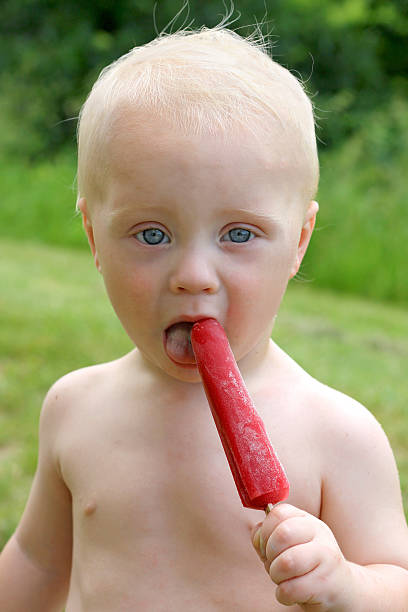 istock Baby Licking Frozen Fruit Popsicle 173315225