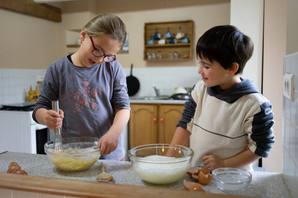 istock brother and sister baking a cake for Christmas 1733152464
