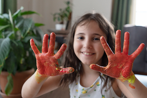 Hands covered in tempura paint.