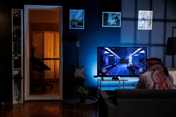 istock Muslim man playing video game on sofa 1733160168