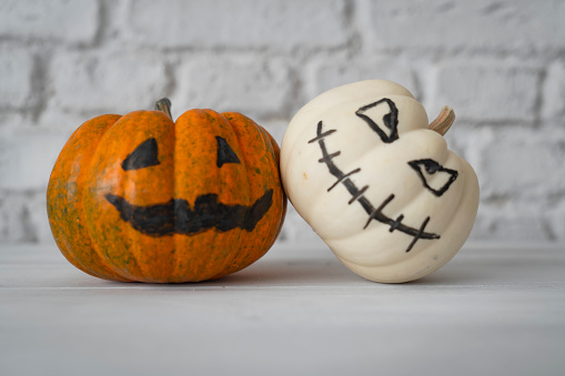 Tasty cookies and sweets for Halloween party on white table, flat lay