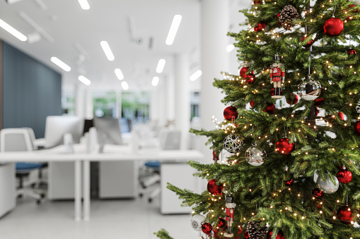 Close-up View Of Christmas Tree With Ornaments In The Office With Blurred Background