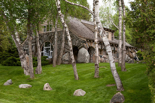 Fairy House in Charlevoix, MI Earl Young house in Charlevoix, Mi, on the shores of Lake Michigan, is one of many so-called fairy tale mushroom houses or hobbit houses. Earl Young designed these fanciful homes in the first half of the 20th century using local boulders and freeform rooflines, resembling story book houses. This house is in the Boulder Park development on Lake Michigan. His houses are only found in Charlevoix. charlevoix photos stock pictures, royalty-free photos & images