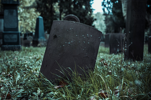 Calgary, Alberta, Canada â October 9, 2022: Tombstones in a Chinese graveyard on the hill in Calgary with a blue sky in the background