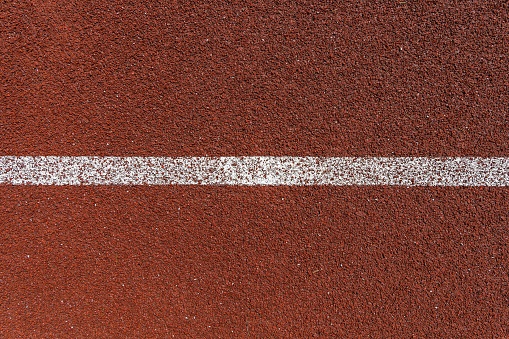 Sports surface, stadium running track. Background for motivation, striving forward. Copyspace.