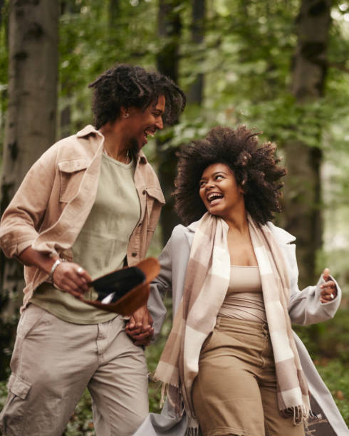 istock Cheerful black couple having fun while running in nature. 1733185402