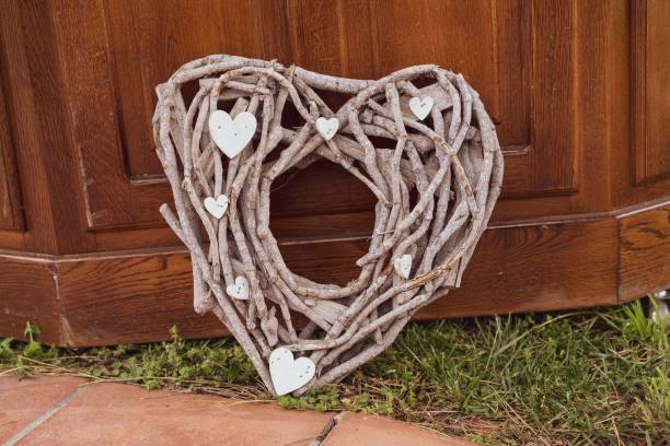 istock Heart-shaped wicker wreath on the ground 1733193607