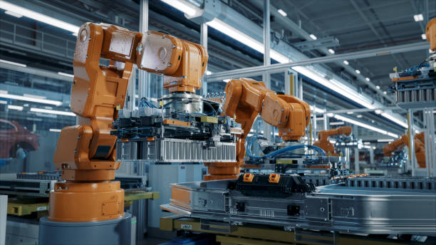 istock Advanced Orange Industrial Robot Arm Assemble EV Battery Pack on Automated Production Line. Modern Electric Car Smart Factory Equipped with Robotic Arms. Battery Module Installation Process. 1733213738