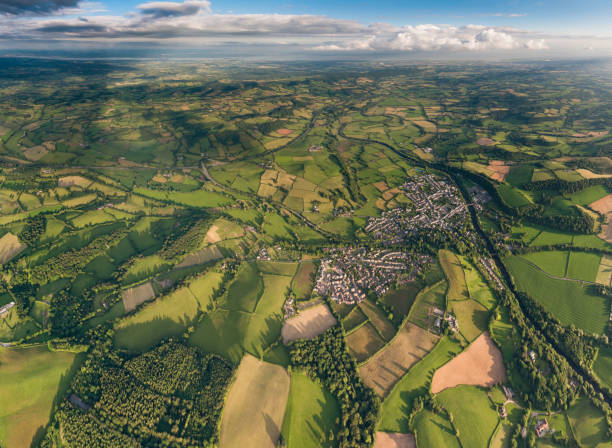istock Aerial vista over country town patchwork fields green summer landscape 173322563